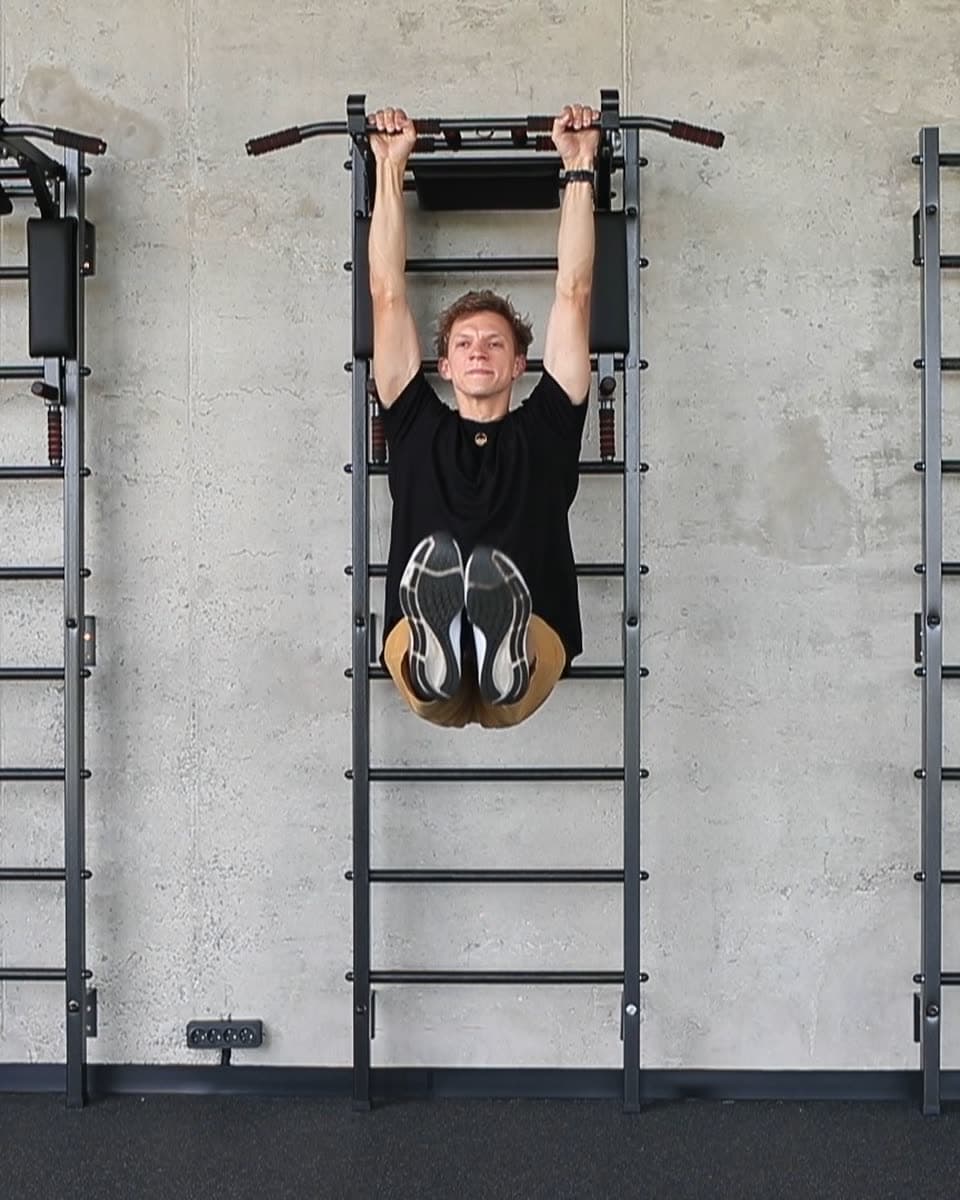 A climber training on wall bars at home